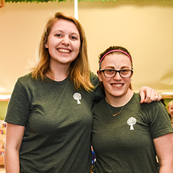 Two teachers posing with arms around each other