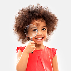 Girl holding a magnifying glass